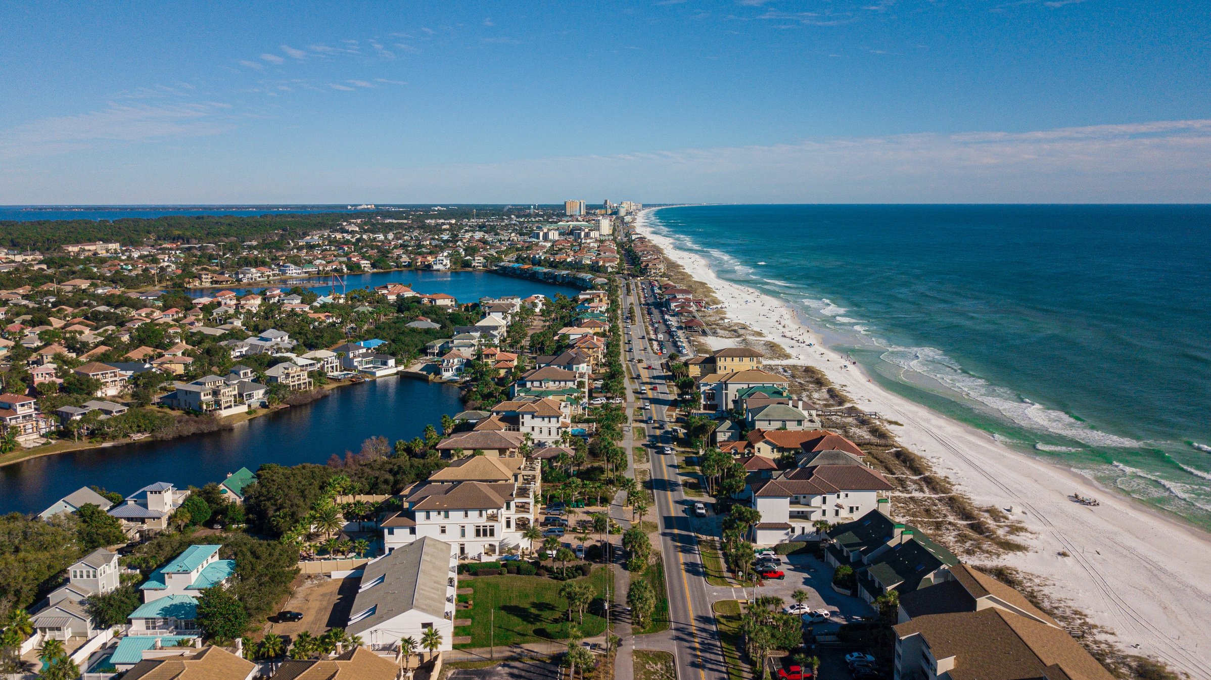 Aerial View of Houses Near A Beach Under Blue Sky